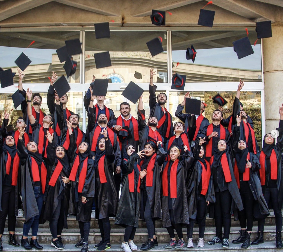 Graduation day at the University of Tehran — mortarboards thrown in the air